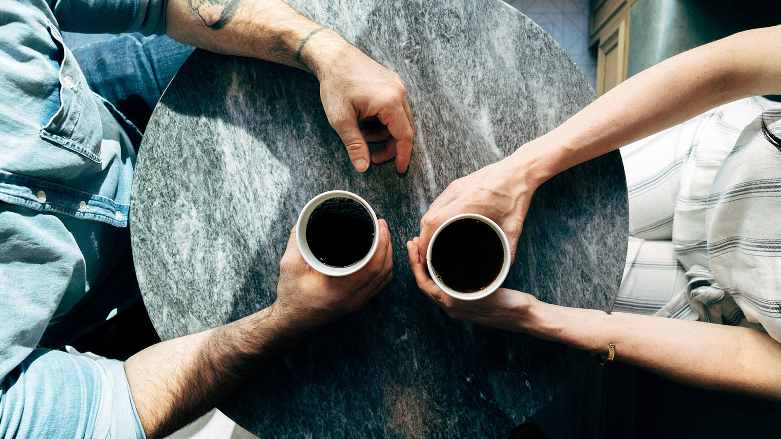 Couple holding coffee cups