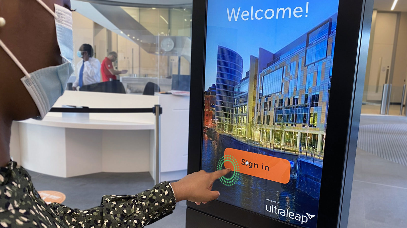 Woman using TouchFree software on an interactive kiosk screen