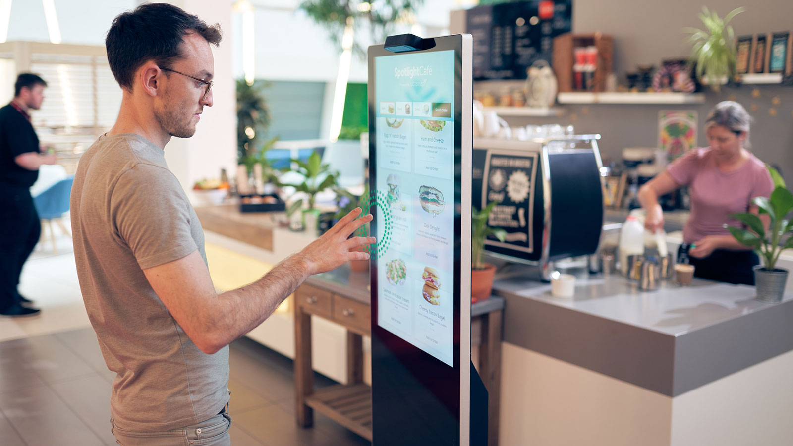 Man ordering lunch using touchless technology on a kiosk